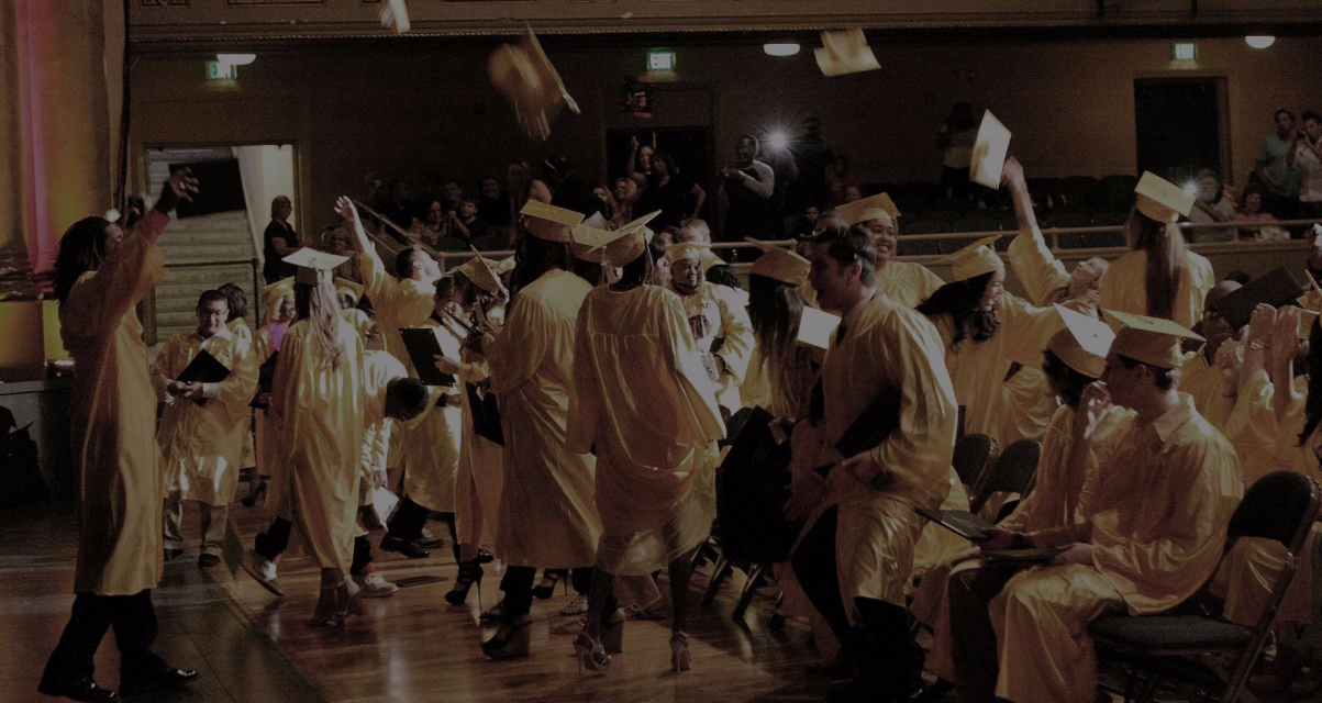 students throwing graduation caps