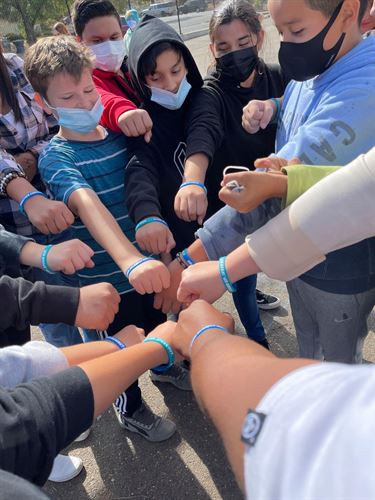 students matching blue wristbands