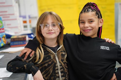 Two students smiling