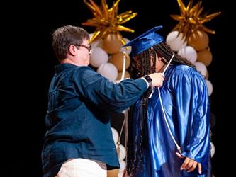students receiving tassle on stage