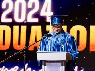 graduate speaking at podium