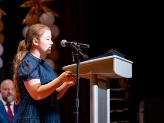 student speaking at podium 