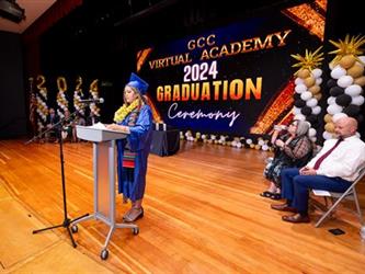 graduate speaking at podium