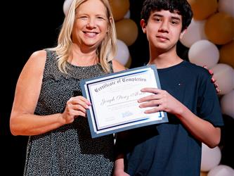 student receiving their certificate