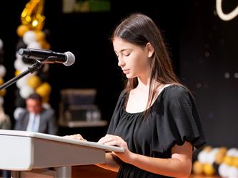 woman speaking at podium
