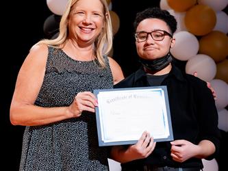 student receiving their certificate