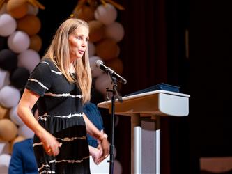 woman speaking at podium 