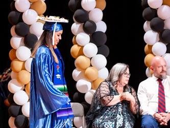 student getting diploma 