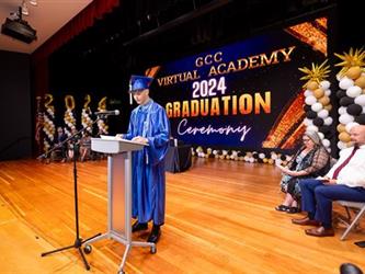 graduate speaking at podium