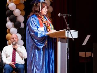 graduate speaking at podium