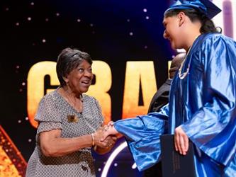 student shaking board president hand 