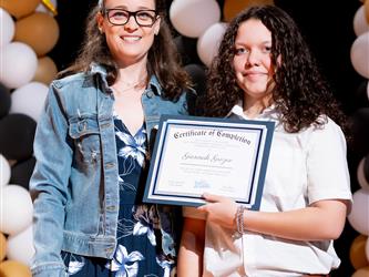 student receiving their certificate
