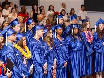 graduates in the crowd facing stage
