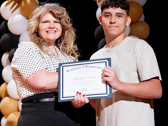 student receiving their certificate
