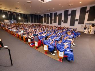 grad students seated in crowd 