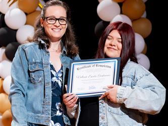 student receiving their certificate