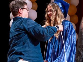 students receiving tassle on stage