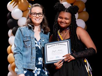 student receiving their certificate