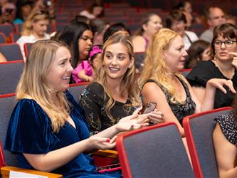 parent happily watching stage
