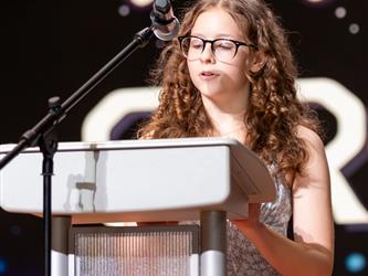 woman speaking at podium