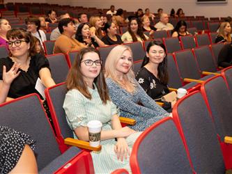 parent happily watching stage