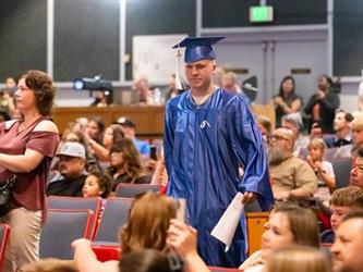student walking to stage
