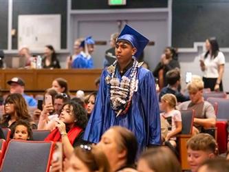 student walking to stage
