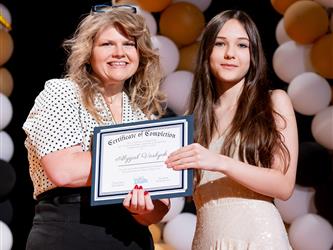 student receiving their certificate
